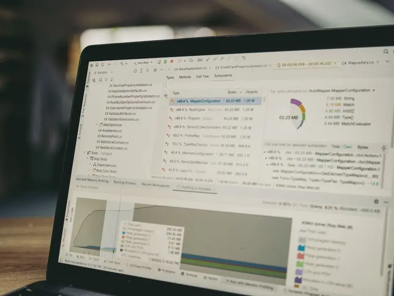 A laptop running data analysis software with tables of results and a chart below