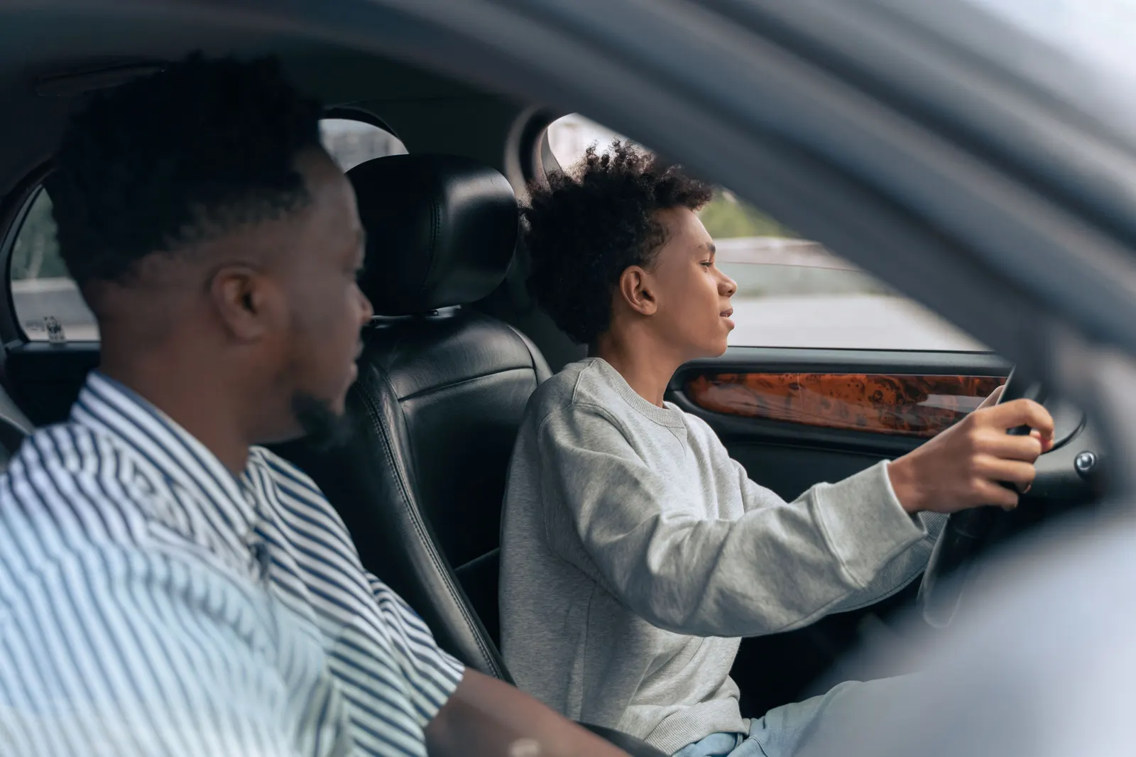 A learner at the wheel while the person in the passenger seat talks them through the controls.