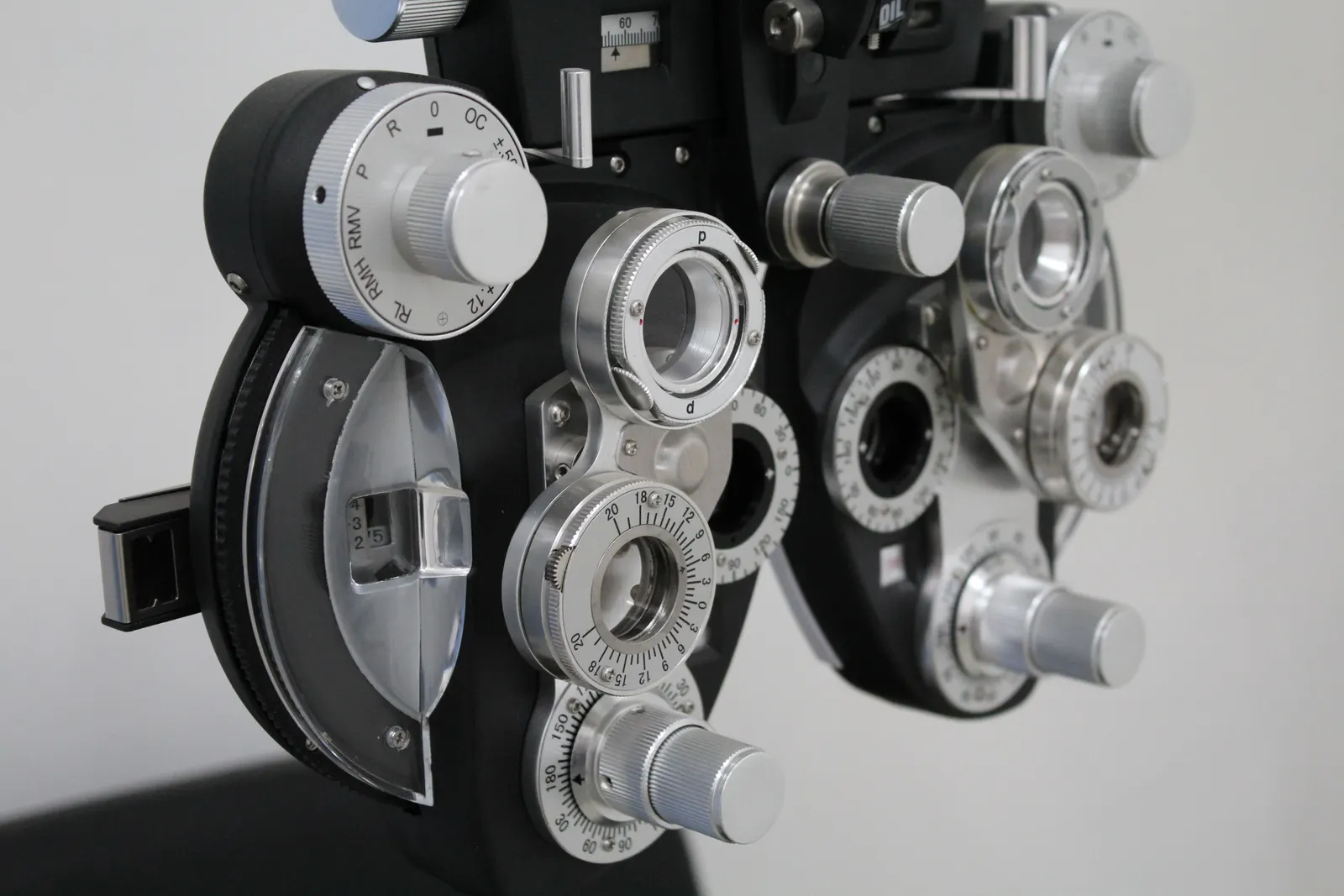 A close-up of a phoropter, the lens instrument used during an eye test.
