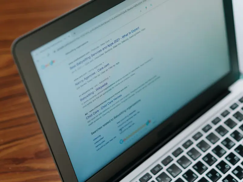 A laptop screen showing a page of search results, viewed at an angle