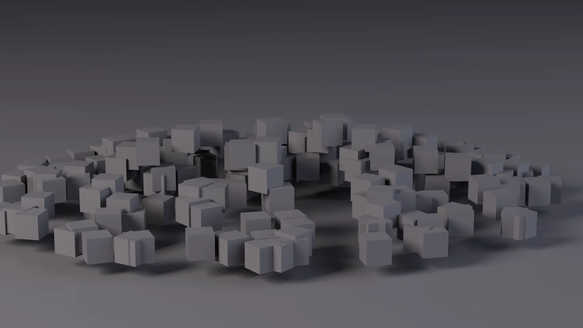 Many small identical blocks gathered on an unlit floor, densest at the centre, reading as one mass rather than as separate pieces.